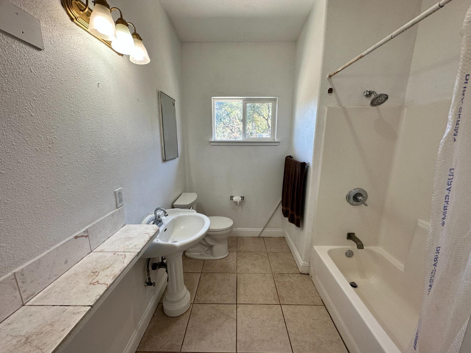 68 Reginald Way Oroville, CA 95966 - Photo 7 of 12 a bathroom with a sink a toilet and shower