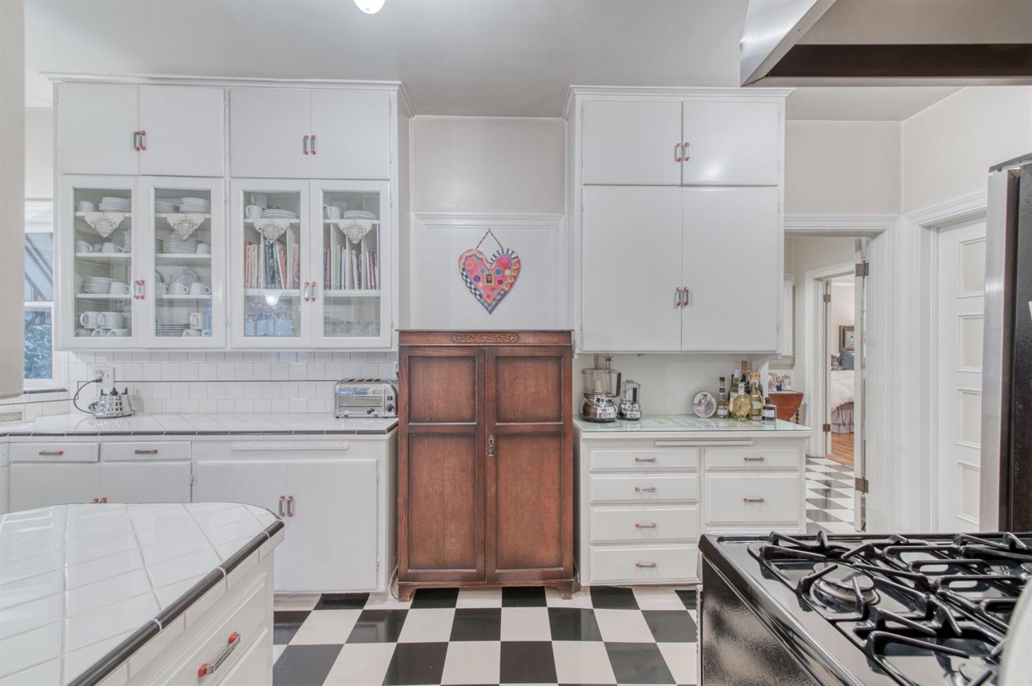 560 East Clinton Avenue Fresno, CA 93704 - Photo 13 of 49 a kitchen with a stove a sink and a refrigerator