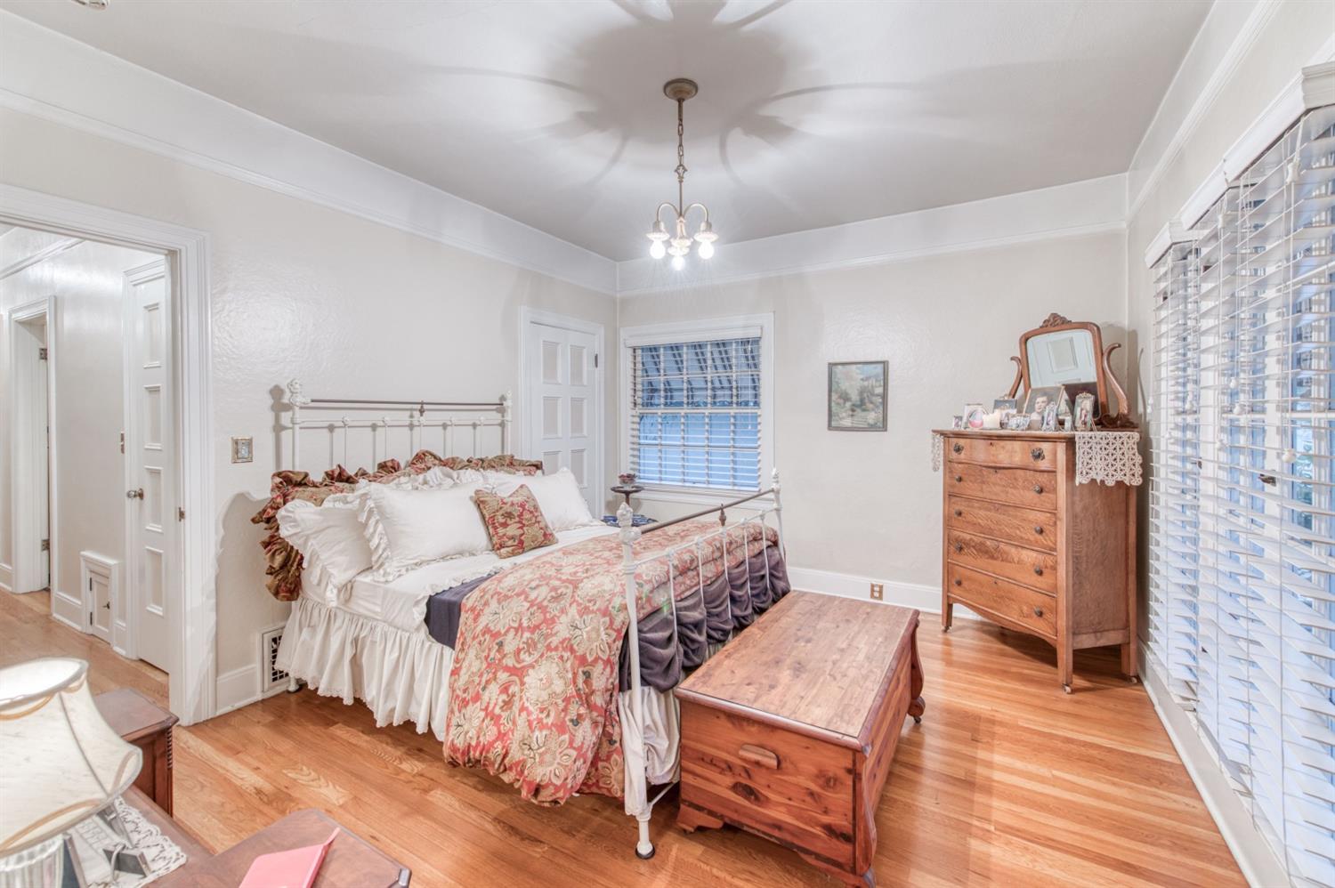 560 East Clinton Avenue Fresno, CA 93704 - Photo 19 of 49 a bedroom with a bed and wooden floor