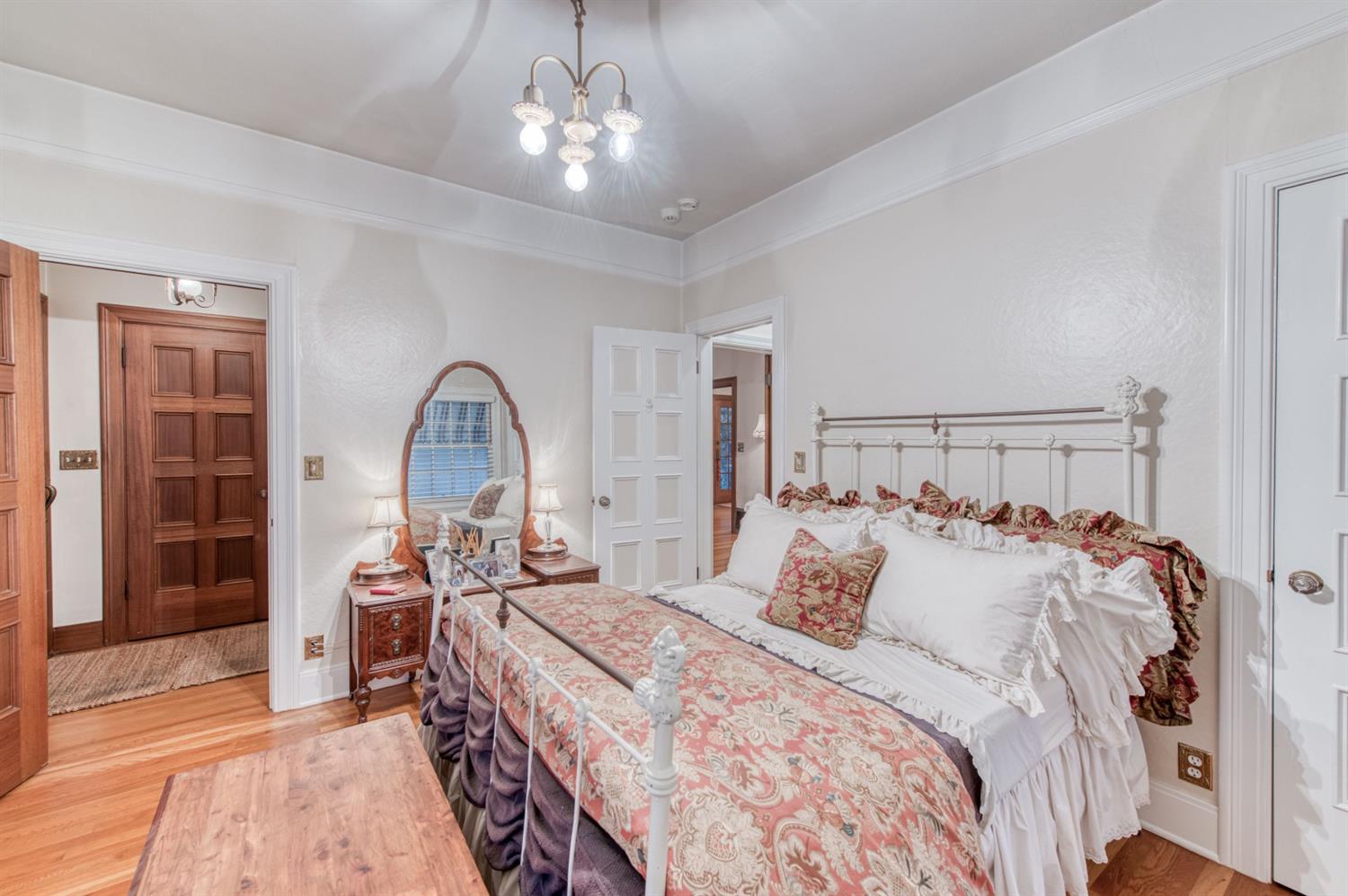 560 East Clinton Avenue Fresno, CA 93704 - Photo 20 of 49 a bedroom with a bed and a chandelier