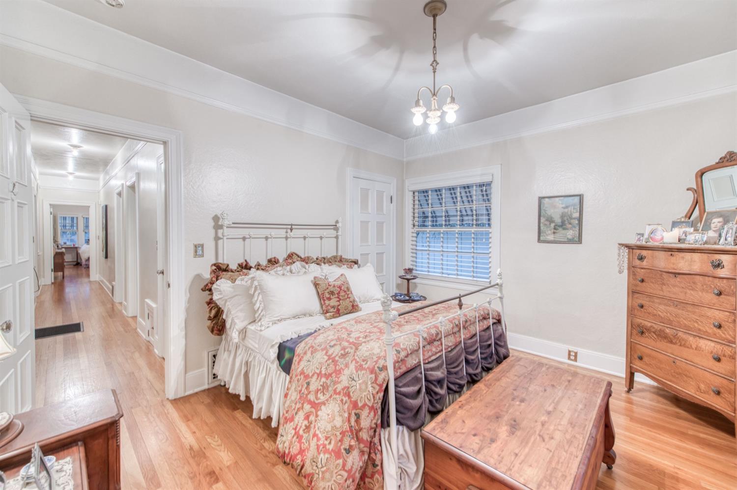 560 East Clinton Avenue Fresno, CA 93704 - Photo 21 of 49 a bed room with a bed and a chandelier