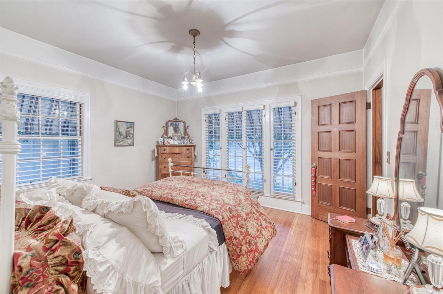 560 East Clinton Avenue Fresno, CA 93704 - Photo 22 of 49 a bedroom with a large bed and a chandelier