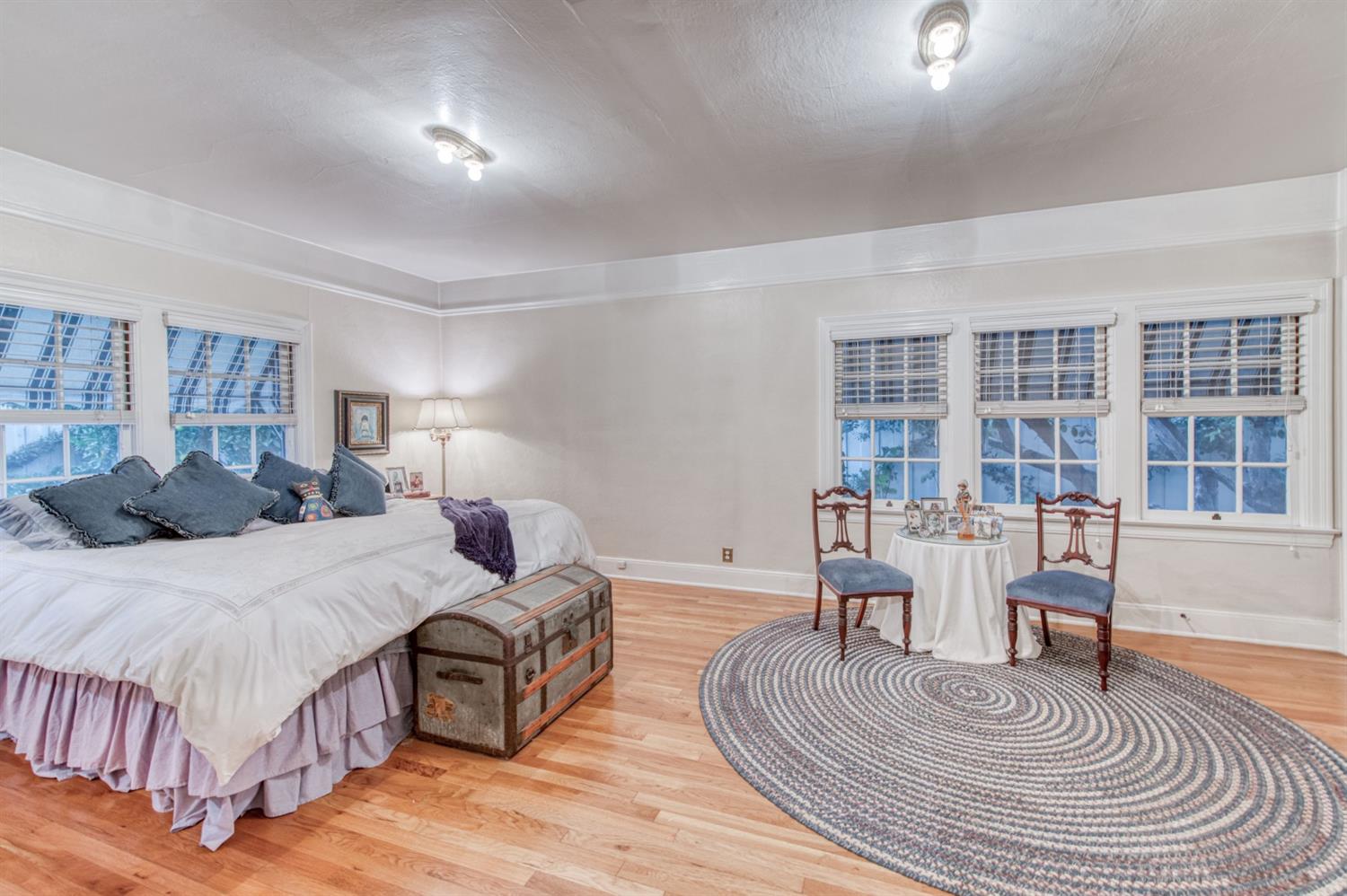 560 East Clinton Avenue Fresno, CA 93704 - Photo 24 of 49 a spacious bedroom with a bed a table and a large window