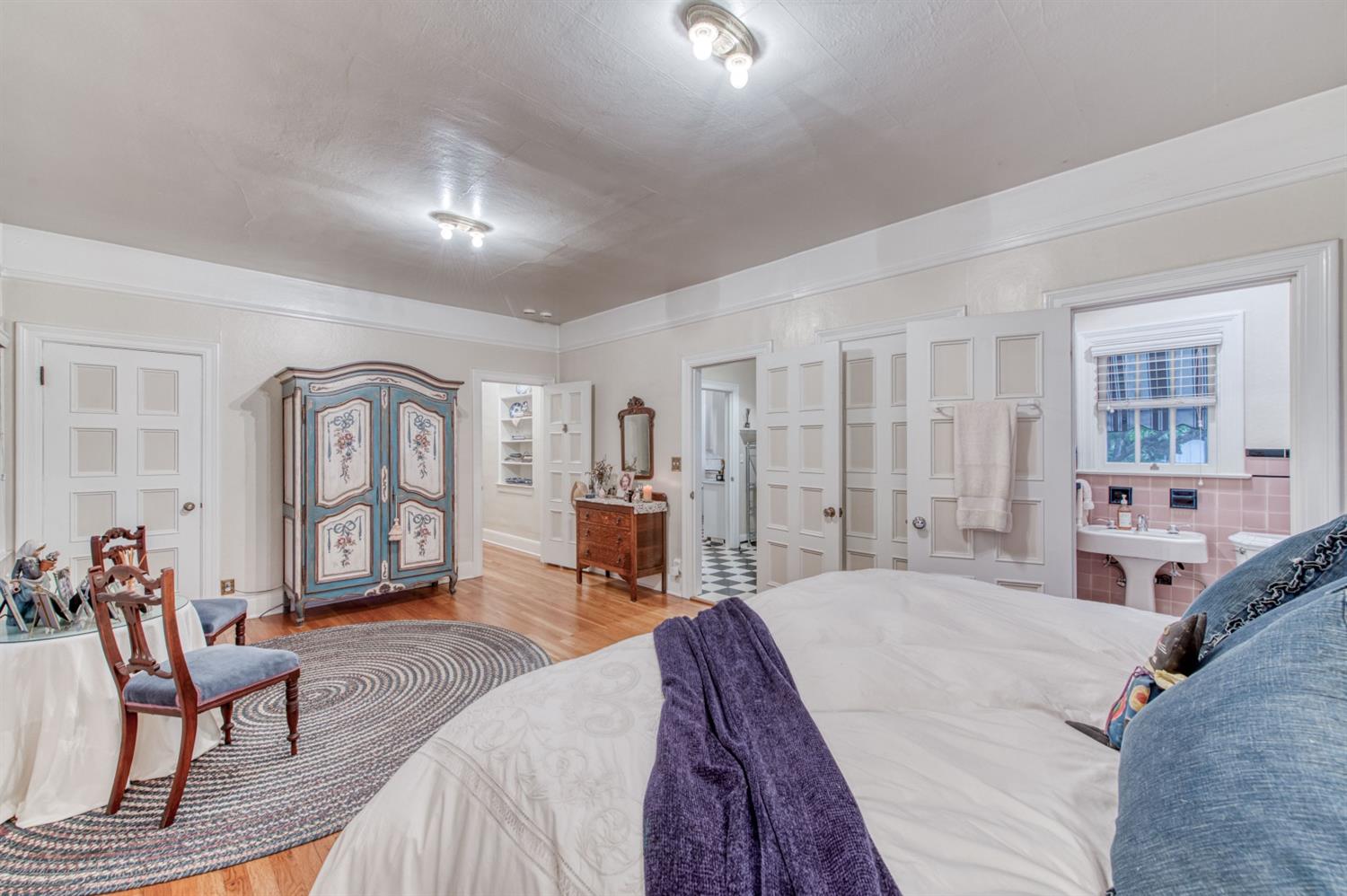 560 East Clinton Avenue Fresno, CA 93704 - Photo 25 of 49 a spacious bedroom with a bed a couch and dresser