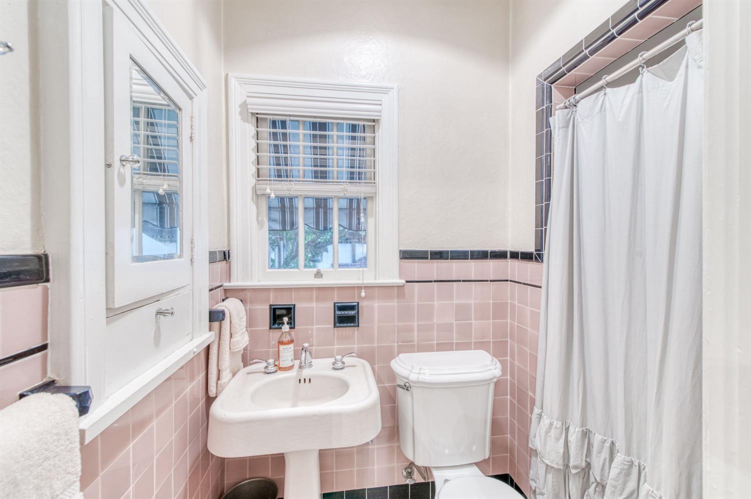 560 East Clinton Avenue Fresno, CA 93704 - Photo 26 of 49 a bathroom with a sink a toilet and shower curtain