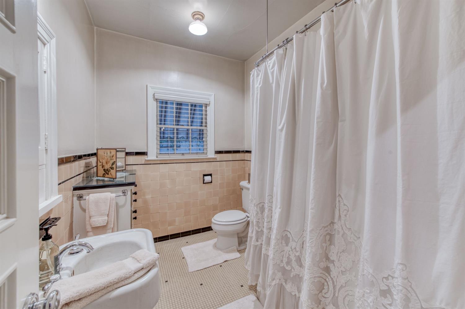 560 East Clinton Avenue Fresno, CA 93704 - Photo 30 of 49 a bathroom with a granite countertop sink toilet and shower curtains