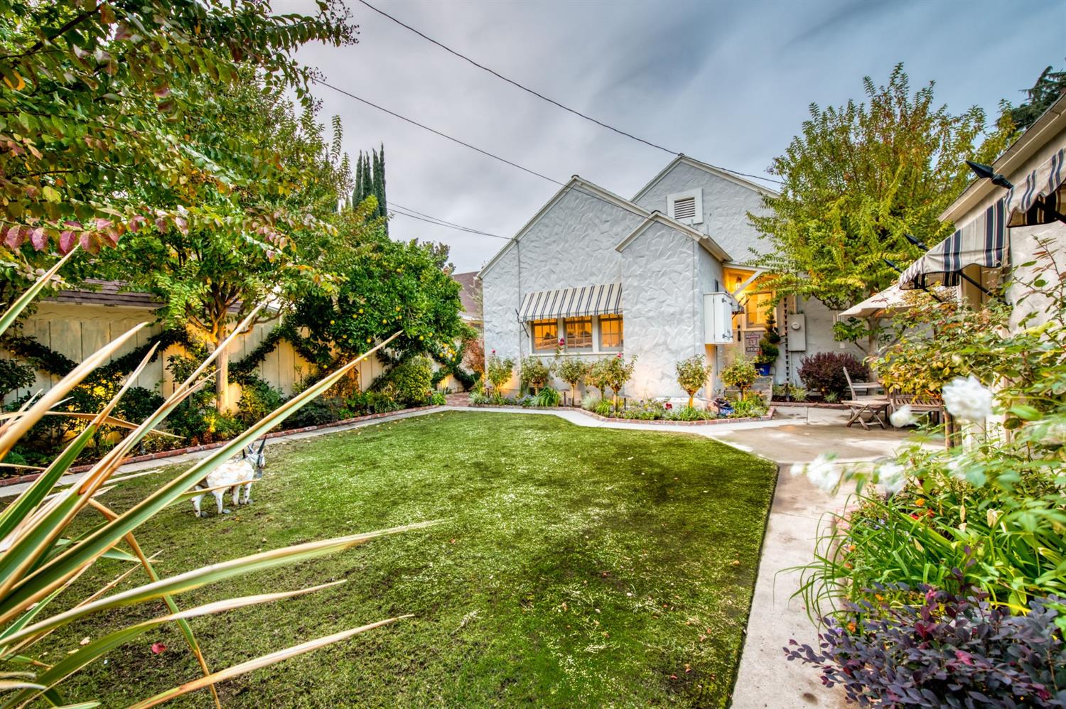 560 East Clinton Avenue Fresno, CA 93704 - Photo 37 of 49 a view of an house with backyard space and a tree