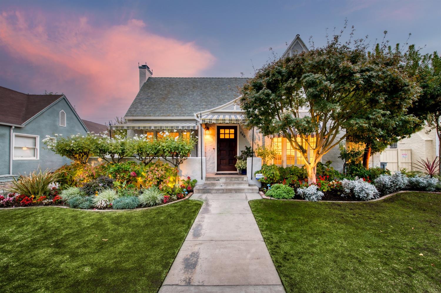560 East Clinton Avenue Fresno, CA 93704 - Photo 43 of 49 a front view of a house with a yard and potted plants