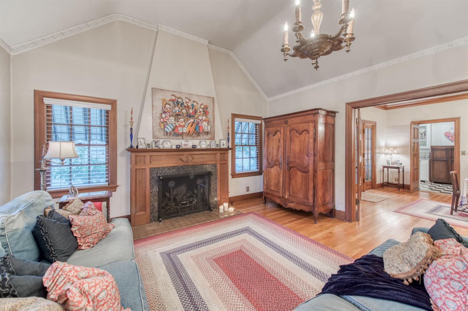 560 East Clinton Avenue Fresno, CA 93704 - Photo 6 of 49 a living room with furniture a fireplace and a chandelier