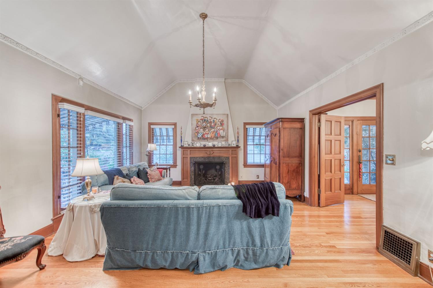 560 East Clinton Avenue Fresno, CA 93704 - Photo 7 of 49 a living room with furniture a fireplace and a chandelier