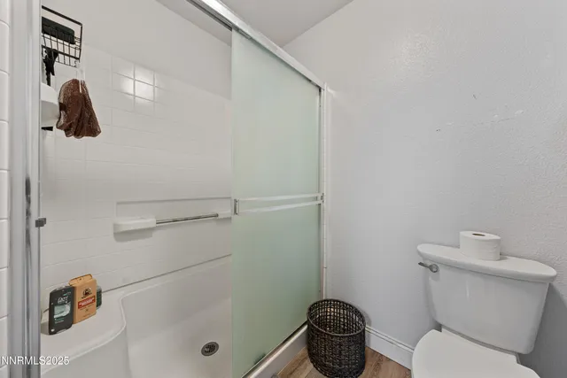 a bathroom with a toilet and a shower