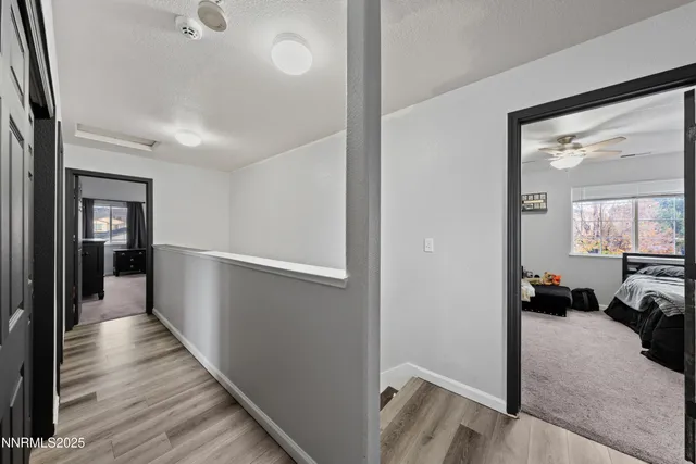 a view of a hallway view with wooden floor and furniture