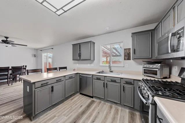 a kitchen with a sink stove and cabinets
