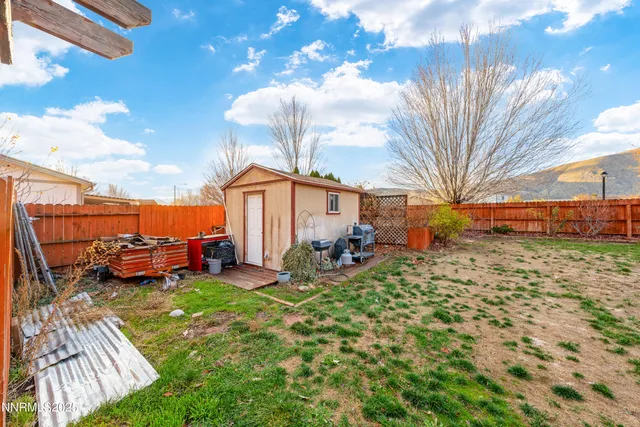 a view of a backyard with couches and table and chairs