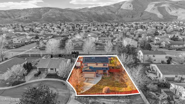 an aerial view of a house with a yard