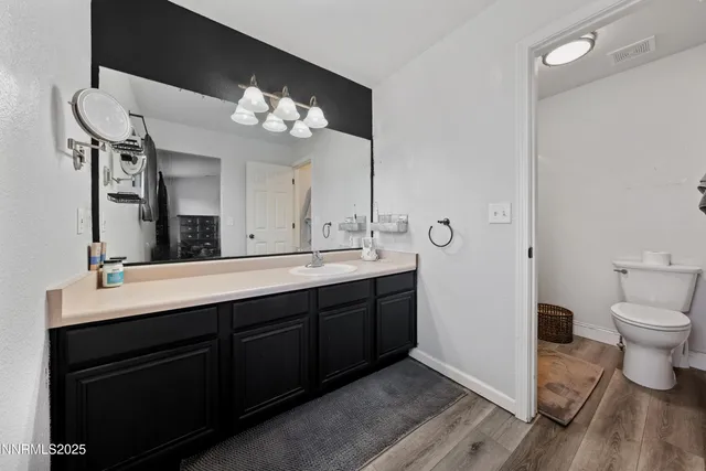 a bathroom with a sink vanity and a mirror