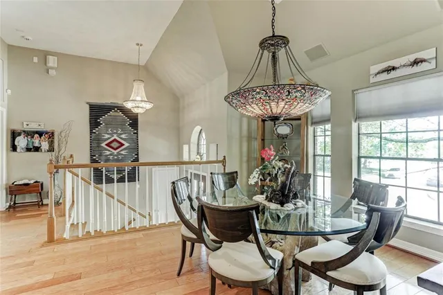 a view of a dining room with furniture wooden floor and chandelier