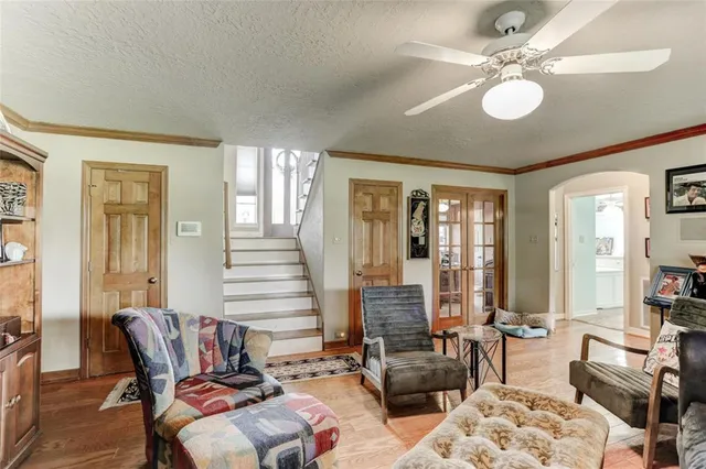 a living room with furniture and floor to ceiling windows