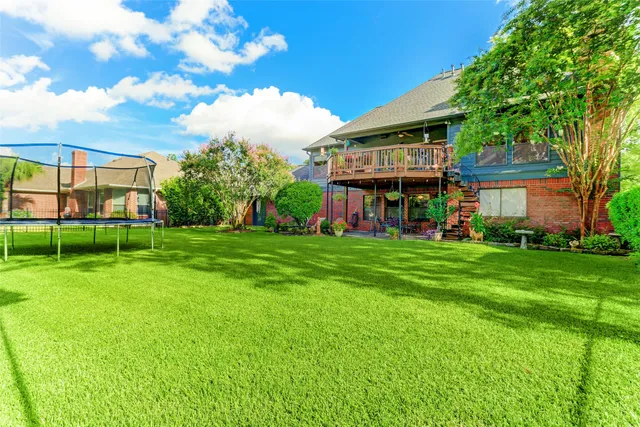 a view of a house with a backyard