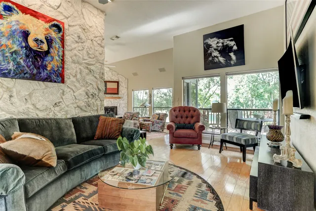 a living room with furniture fireplace and a large window