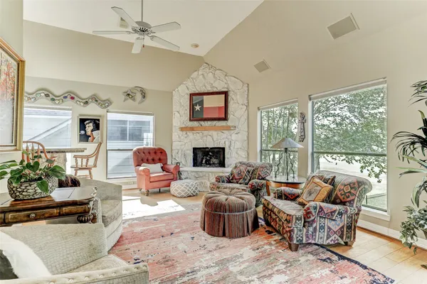 a living room with furniture large window and flat screen tv