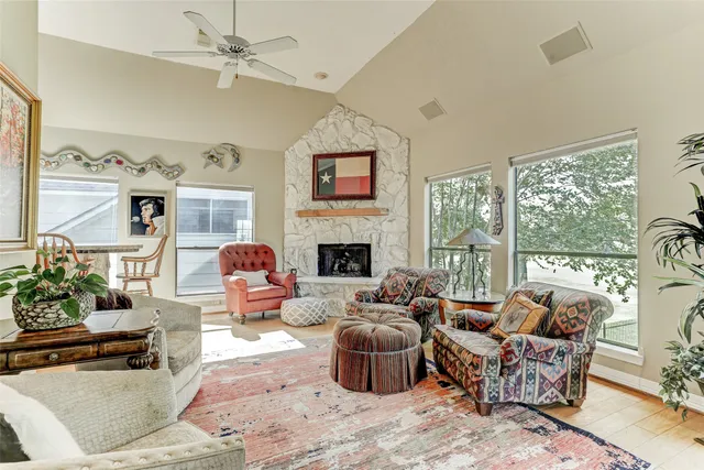 a living room with furniture large window and flat screen tv