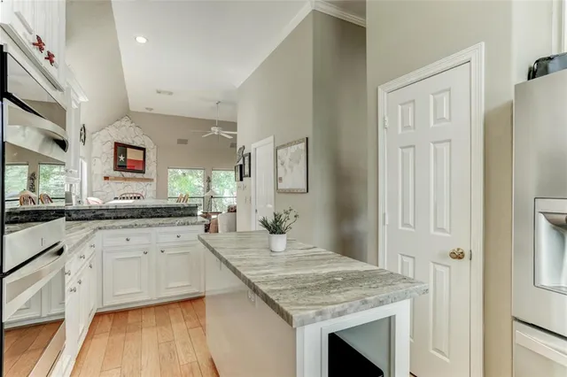 a kitchen with granite countertop cabinets stainless steel appliances and a counter space