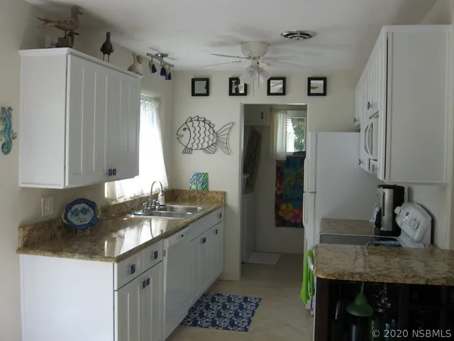 a kitchen with a sink stove and refrigerator