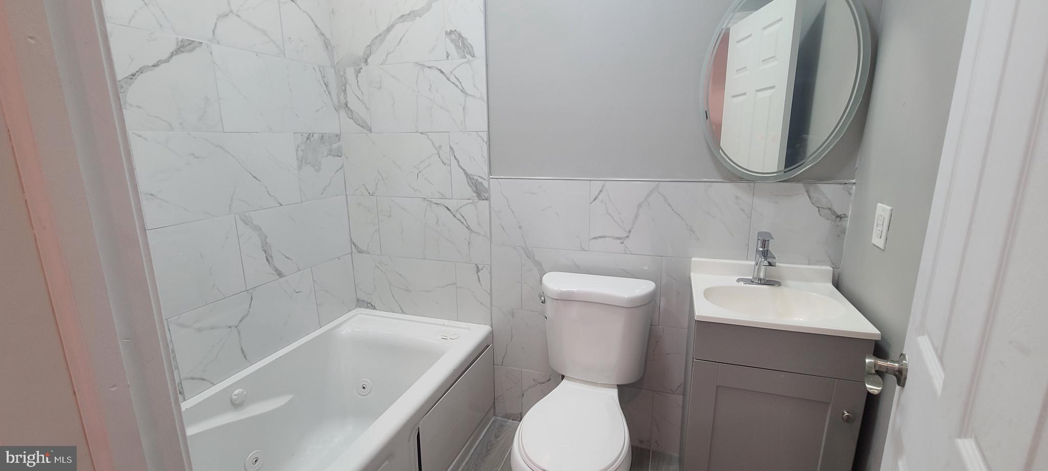 1817 North 26th Street Philadelphia, PA 19121 - Photo 13 of 25 a bathroom with a toilet sink and mirror