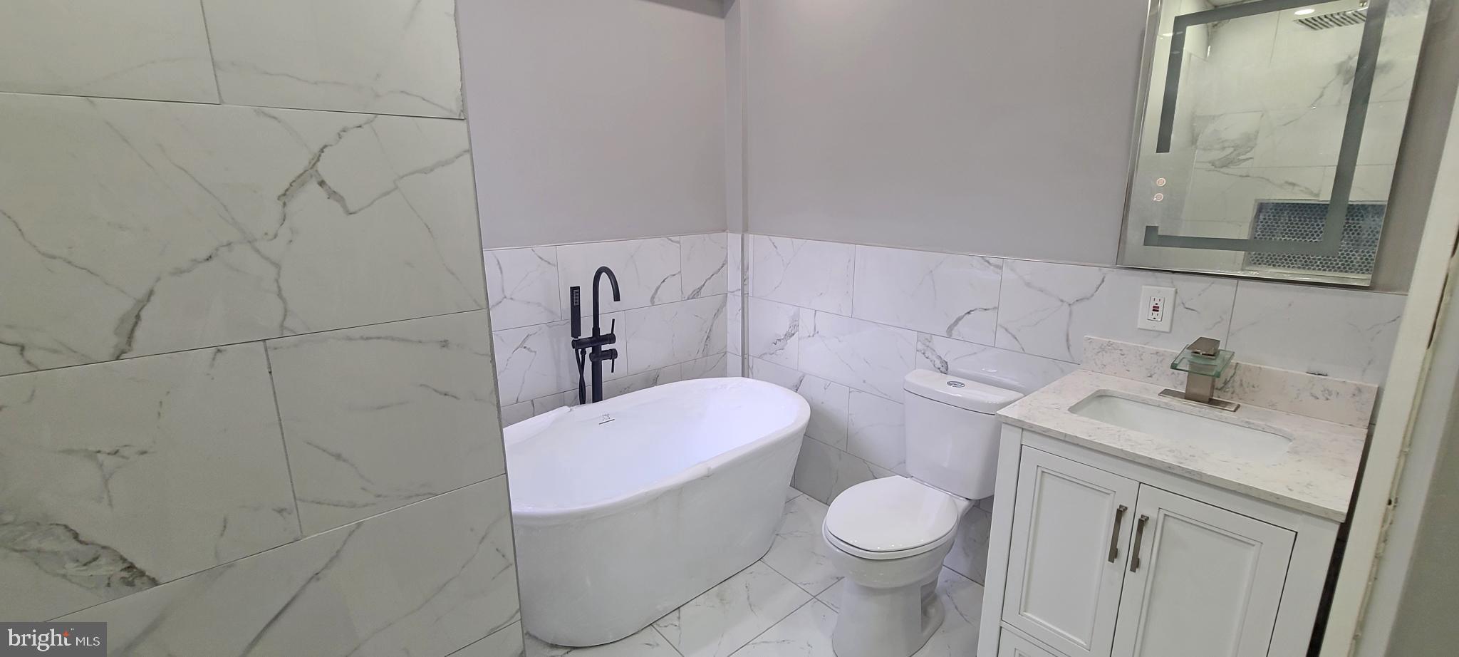 1817 North 26th Street Philadelphia, PA 19121 - Photo 18 of 25 a white toilet sitting next to a bathroom sink