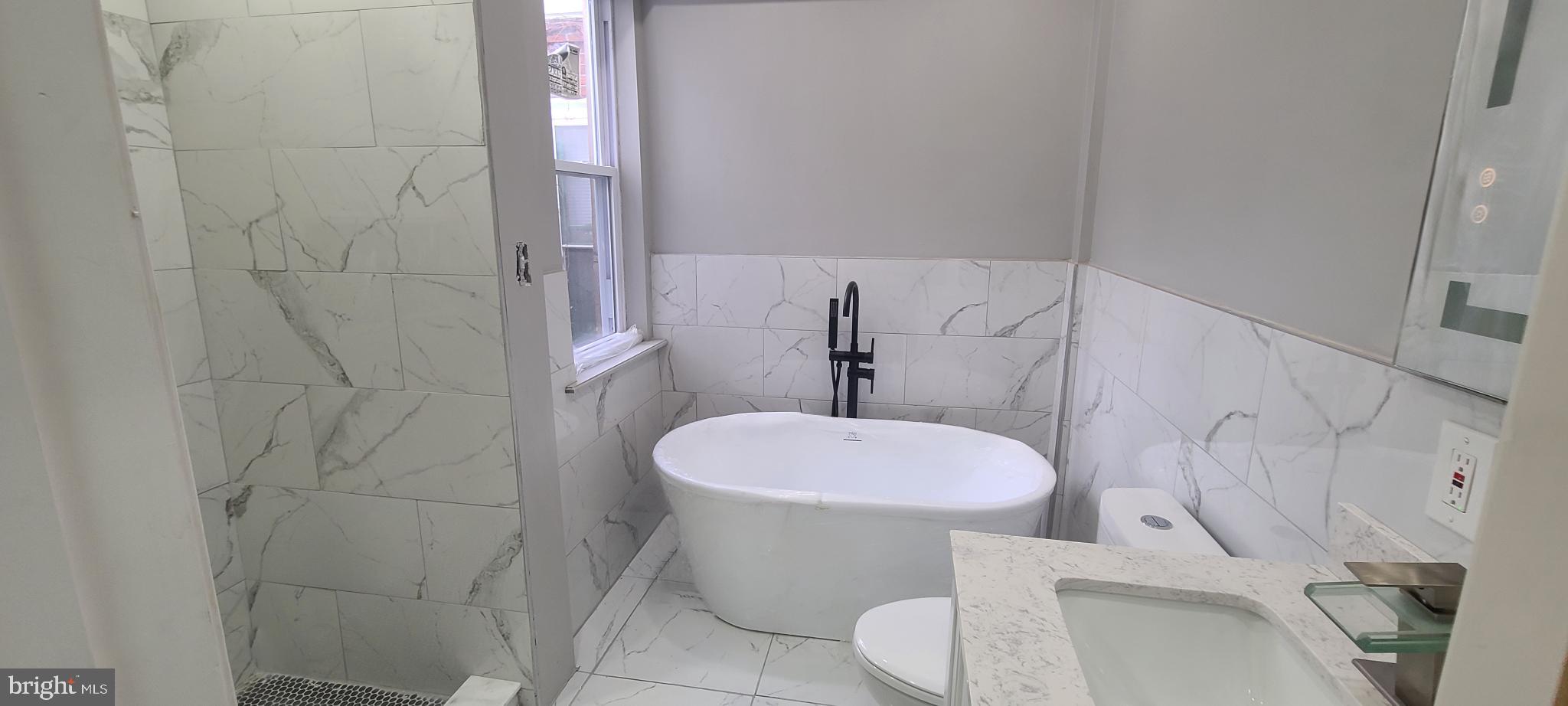 1817 North 26th Street Philadelphia, PA 19121 - Photo 19 of 25 a white toilet sitting next to a bathroom sink