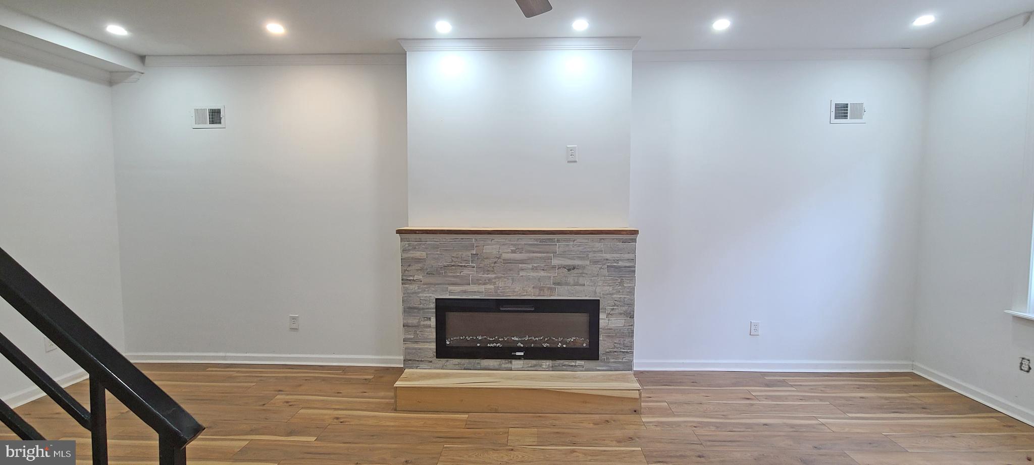 1817 North 26th Street Philadelphia, PA 19121 - Photo 6 of 25 a view of an empty room with wooden floor and a fireplace