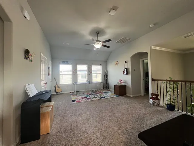 a living room with furniture ceiling window and a ceiling fan
