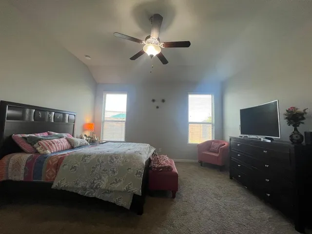 a bedroom with two beds and a chandelier