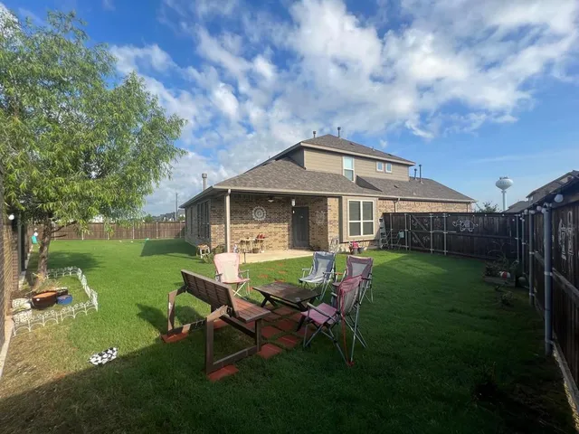 a view of a house with a yard porch and sitting area