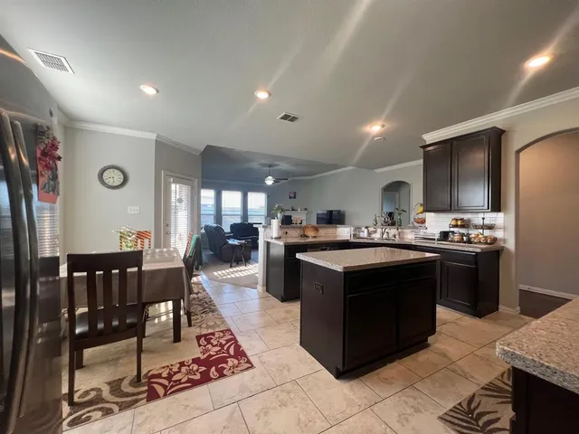 a kitchen with stainless steel appliances granite countertop a stove and a refrigerator