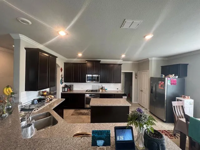 a kitchen with a sink stove and refrigerator