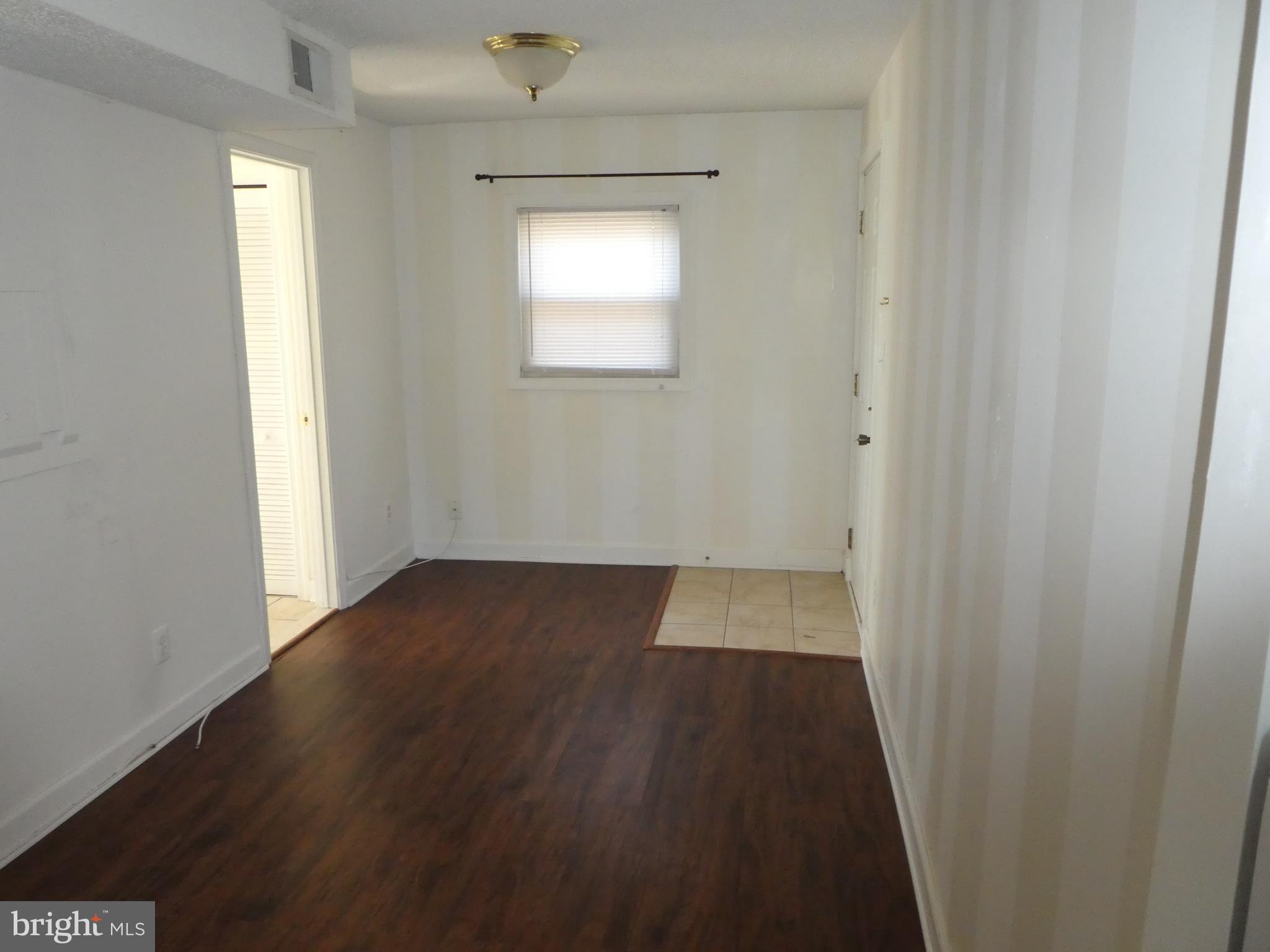 402 C Street, Unit 203 Quantico, VA 22134 - Photo 13 of 14 an empty room with wooden floor and windows