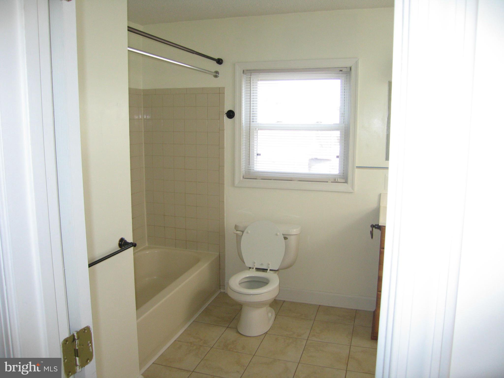 402 C Street, Unit 203 Quantico, VA 22134 - Photo 3 of 14 a white toilet sitting next to a bath tub