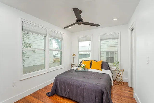 a view of a livingroom with wooden floor and a window