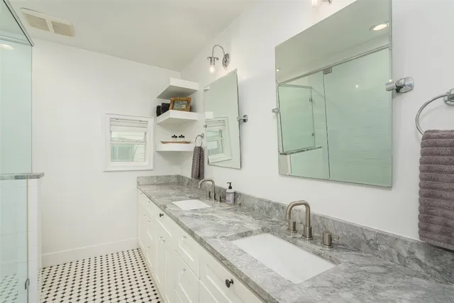 a bathroom with a sink a mirror and a shower