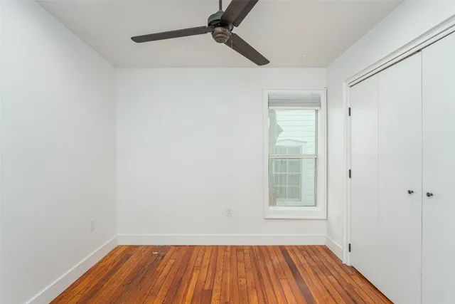 a view of a brick house with wooden fence