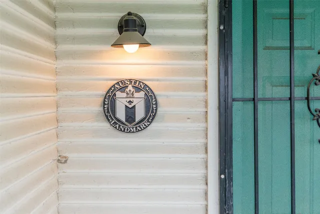 a view of a hallway with wooden floor and a glass door