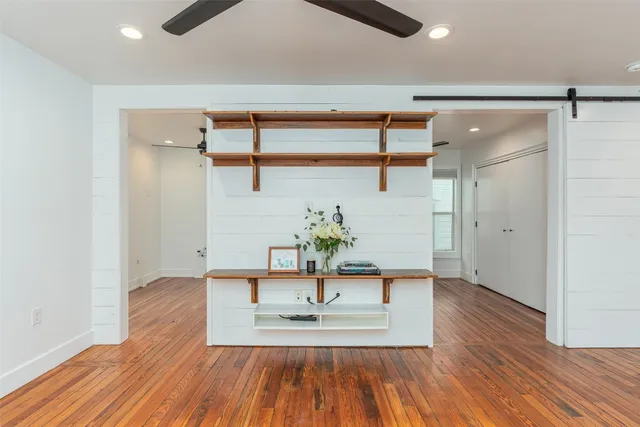 a kitchen with a refrigerator sink and cabinets