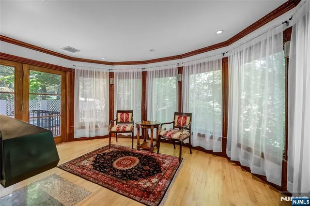 a living room with furniture and a floor to ceiling window