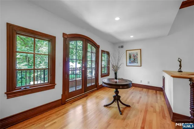 a view of a room with furniture and wooden floor