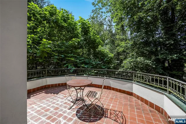 a view of balcony with wooden floor and seating space