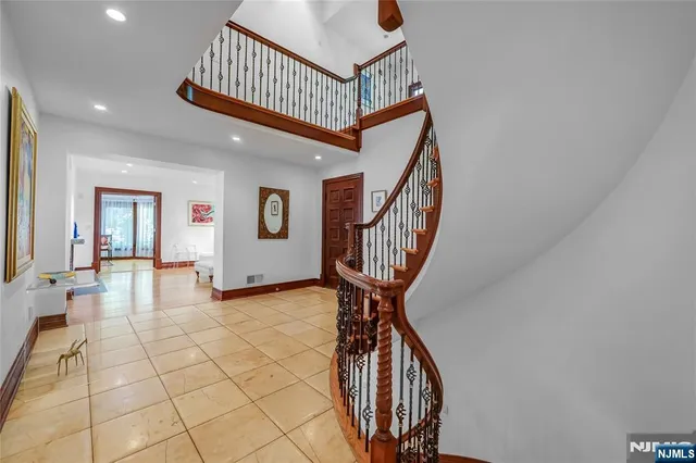 a view of a hallway with a livingroom and entryway