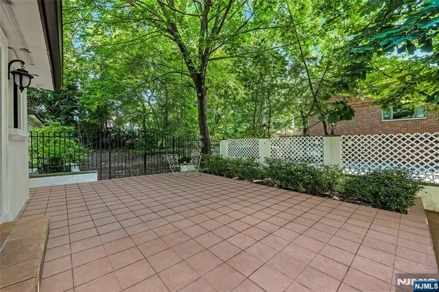 a patio of a house with lots of green space