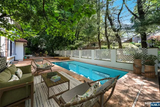 swimming pool view with a seating space